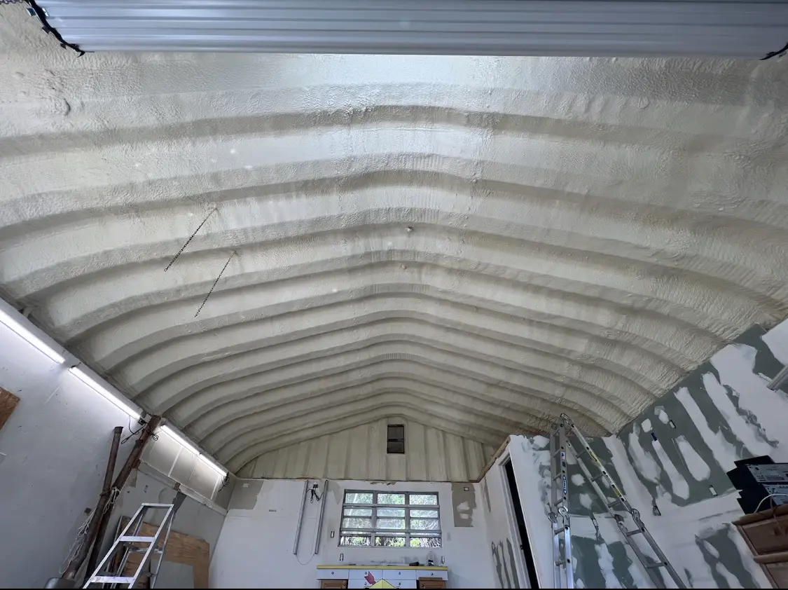 Spray polyurethane foam applied to the underside of a metal roof deck in Hope